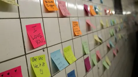 NEW YORK, NY - NOVEMBER 10: Post-it notes, many with politically themed messages, hang on a wall at the 6th Avenue subway station as part of a public art project entitled 'Subway Therapy,' November 10, 2016 in New York City. Artist Matthew Chavez, who goes by 'Levee,' created the 'Subway Therapy' wall to offer New Yorkers a chance to write down their feelings in the wake of the presidential election.   Drew Angerer/Getty Images/AFP